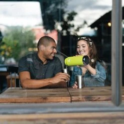 Klean Kanteen Insulated TK Wide With Café Cap 946ml - Black -Vango || Kampa || Outwell Shop K32TKWSSL JP bottle brewery pouring lifestyle 1